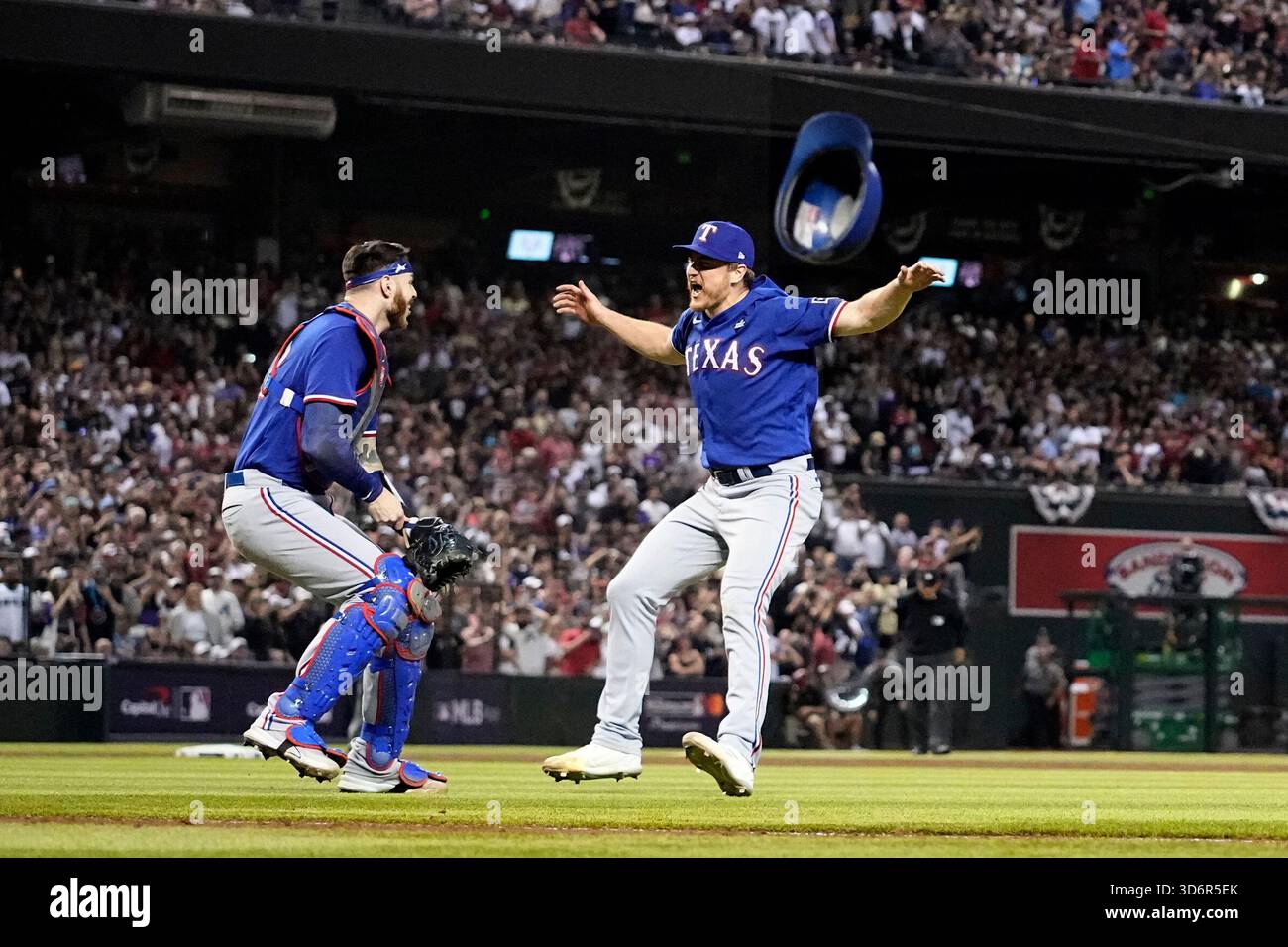 FILE - Texas Rangers catcher Jonah Heim, left, and relief pitcher Josh Sborz celebrate after Game 5 of the baseball World Series against the Arizona Diamondbacks Wednesday, Nov. 1, 2023, in Phoenix. (AP Photo/Godofredo A. Vásquez, File) Foto Stock