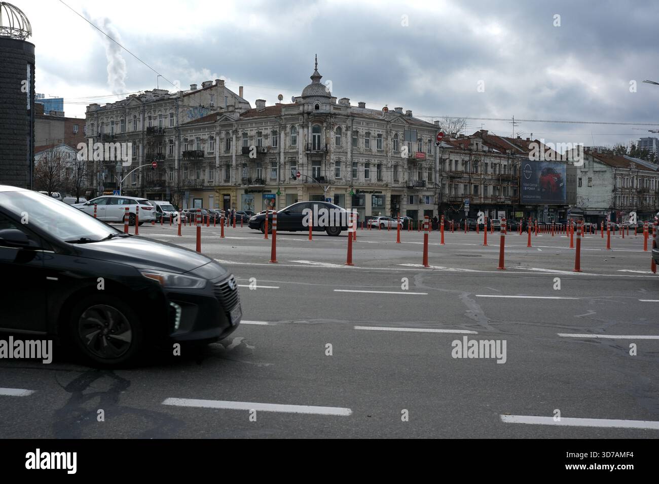 Una vivace strada cittadina presenta edifici classici sotto un cielo coperto, con le auto in movimento. 24 novembre 2025 Kiev, Ucraina, Galitska Square. Foto Stock