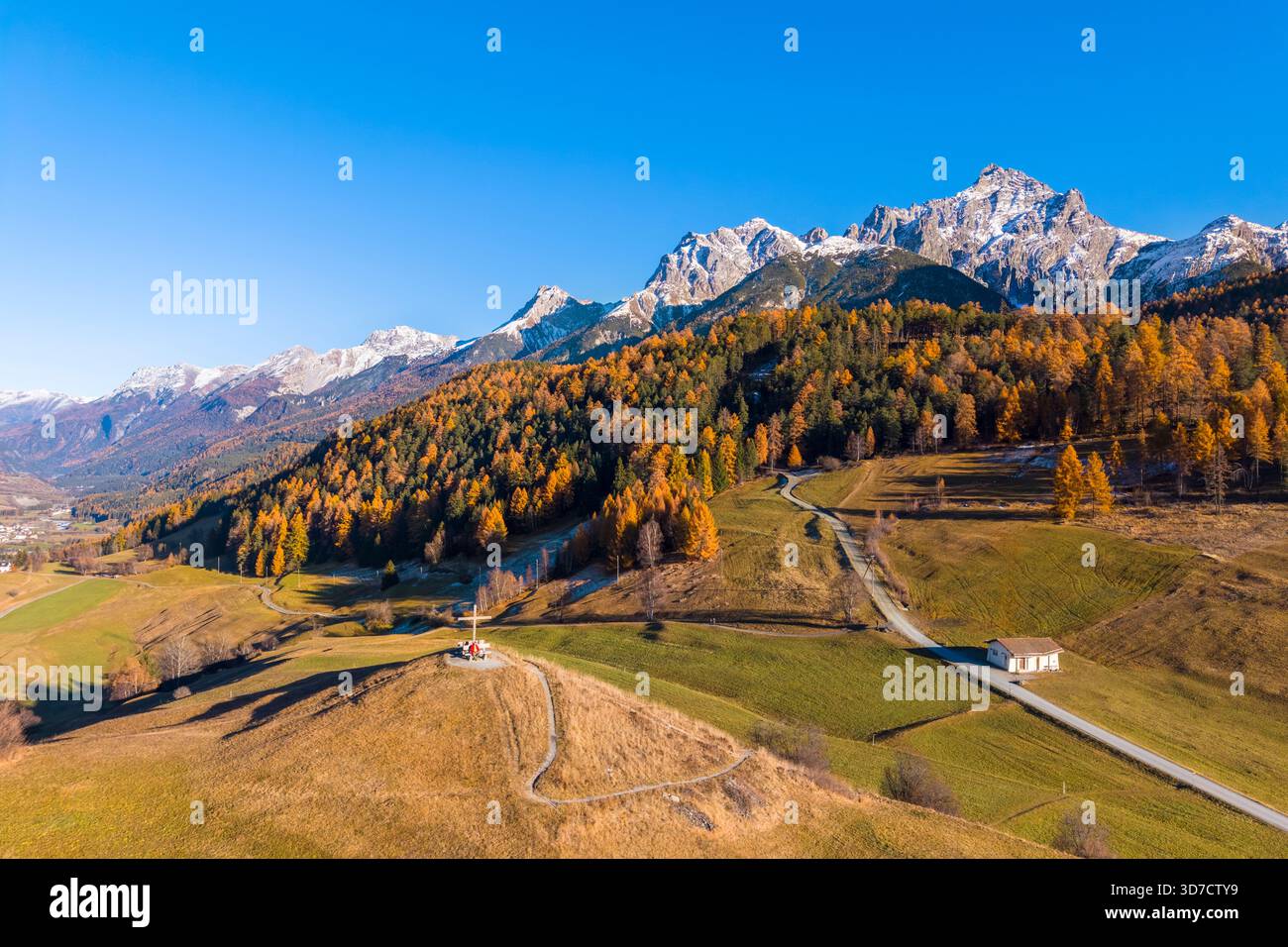 Vista aerea di una persona che ammira le montagne che circondano Tarasp in autunno. Bassa Engadina, Cantone dei Grigioni, Svizzera, Europa. Foto Stock