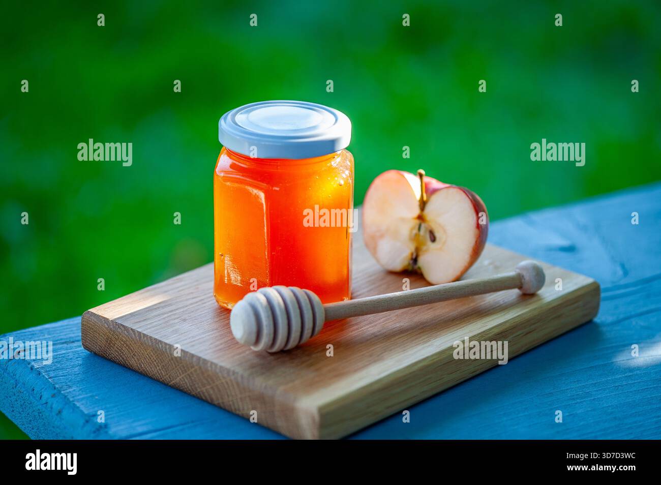 Marmellata di mele fatta in casa in barattolo con mela fresca e cucchiaia di legno sul tagliere. Spalmazione di frutta naturale. Foto Stock