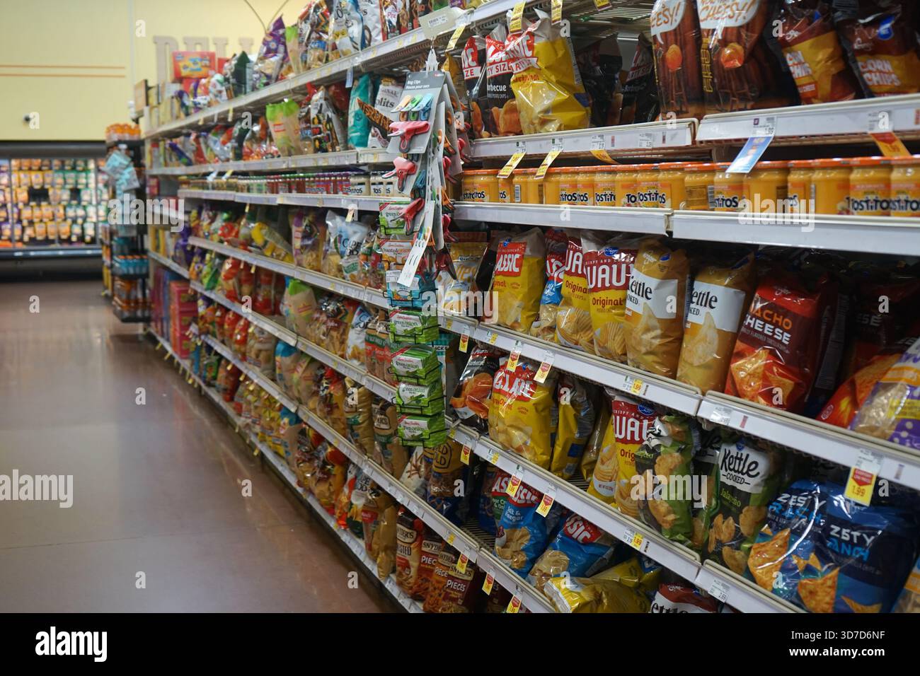 Sacchetti di patatine fritte sugli scaffali nel corridoio degli snack di un negozio di alimentari Smith's. Foto Stock