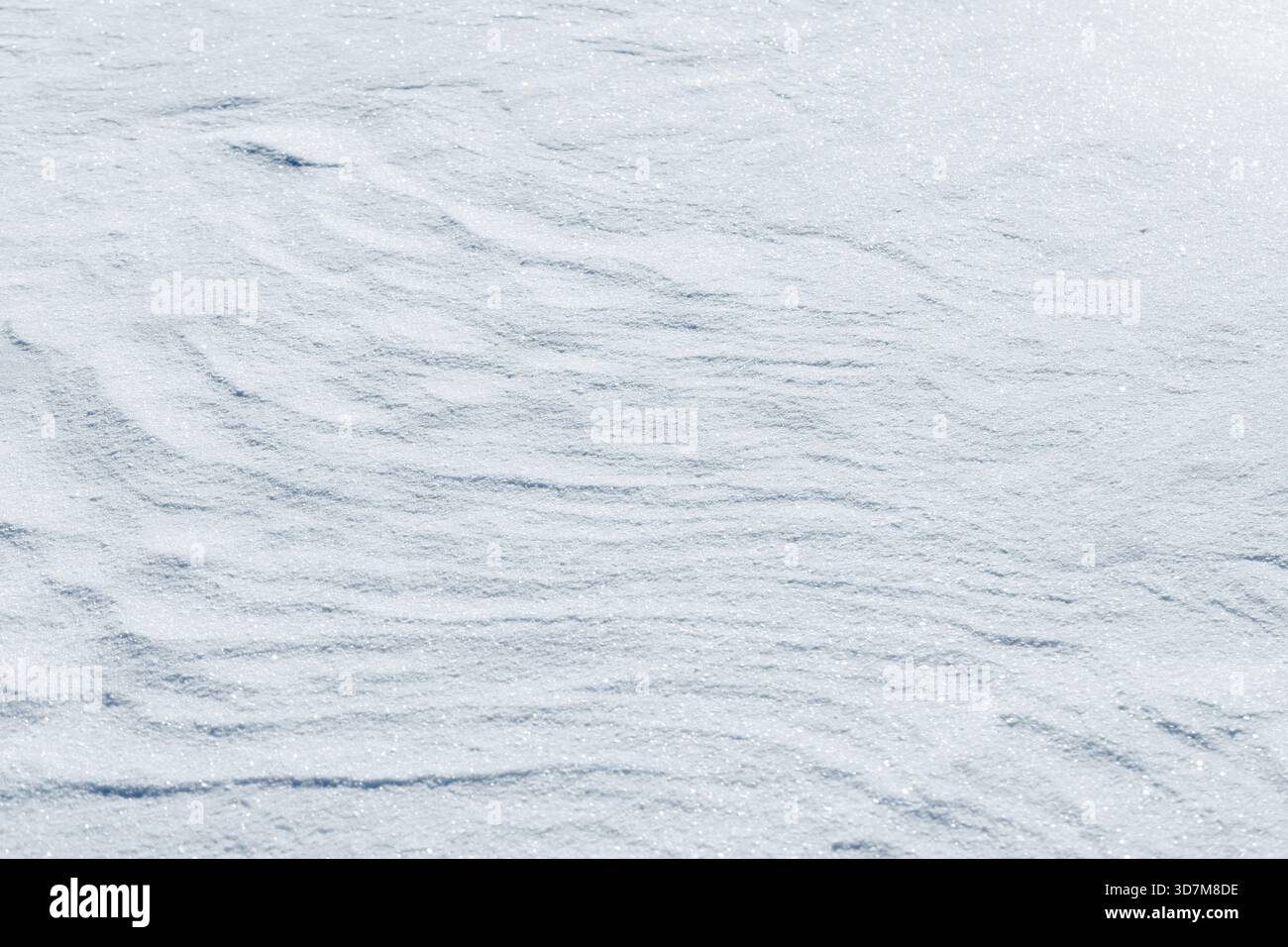 Superficie innevata incontaminata con creste sottili e scintillanti gelate, che trasmettono freddo, calma e quiete in inverno. Texture foto di sfondo naturale astratta Foto Stock