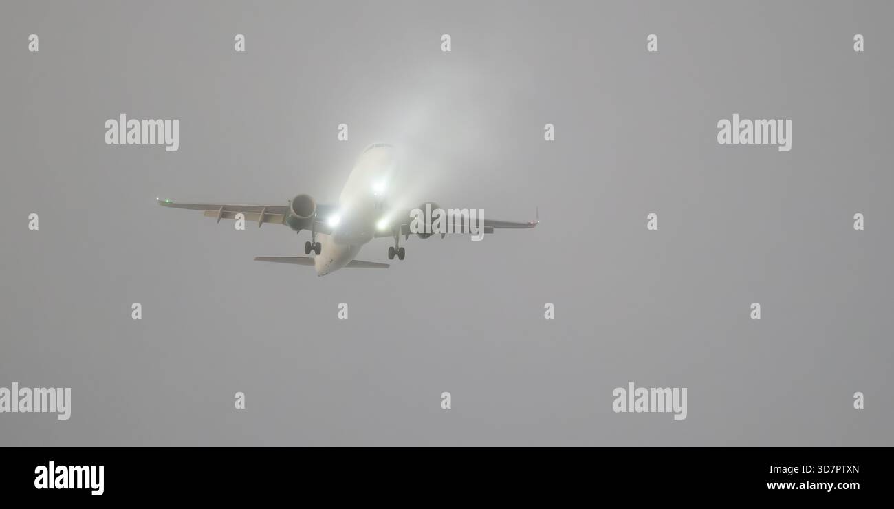 Aeromobili passeggeri commerciali che scendono attraverso lo strato nuvoloso durante l'avvicinamento all'atterraggio Foto Stock