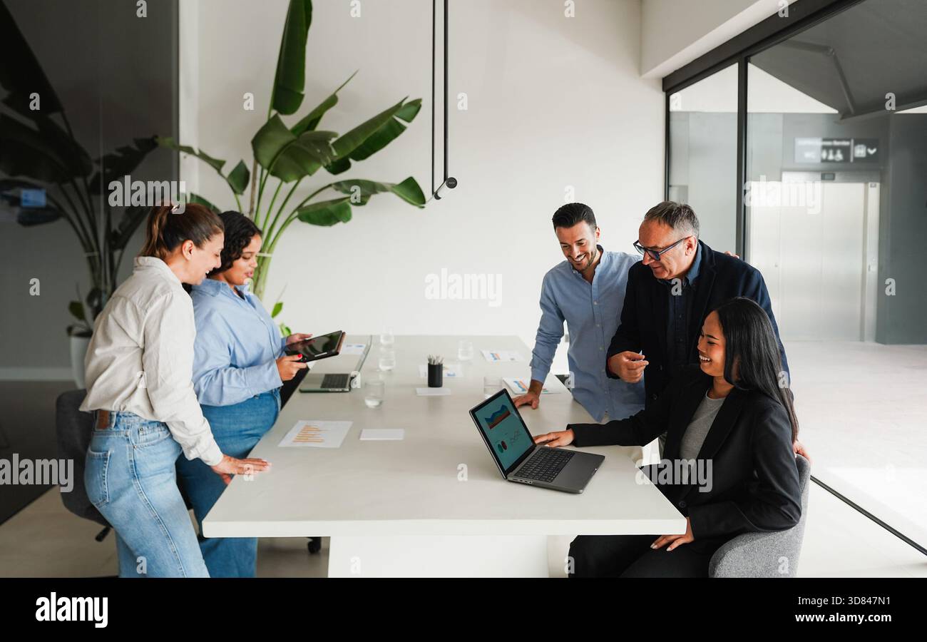 Uomini d'affari multigenerazionali che condividono idee all'interno dell'ufficio aziendale - colleghi multirazziali che discutono di nuovi progetti finanziari - brainstorming Foto Stock