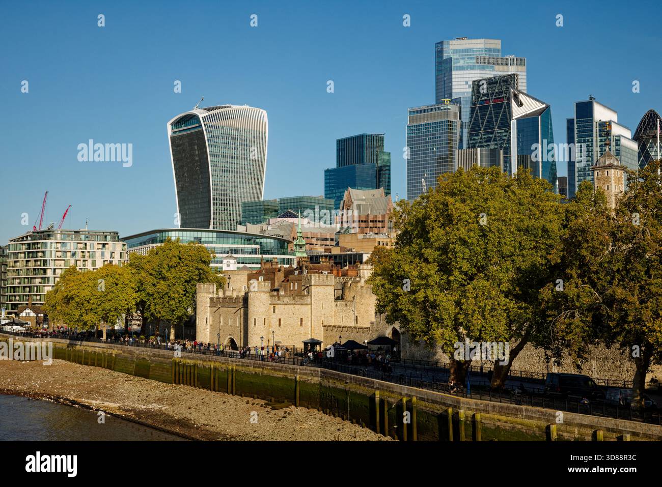 I grattacieli della torre Square Mile sopra le antiche mura della Torre di Londra sulle rive del Tamigi, Londra, Inghilterra. Foto Stock
