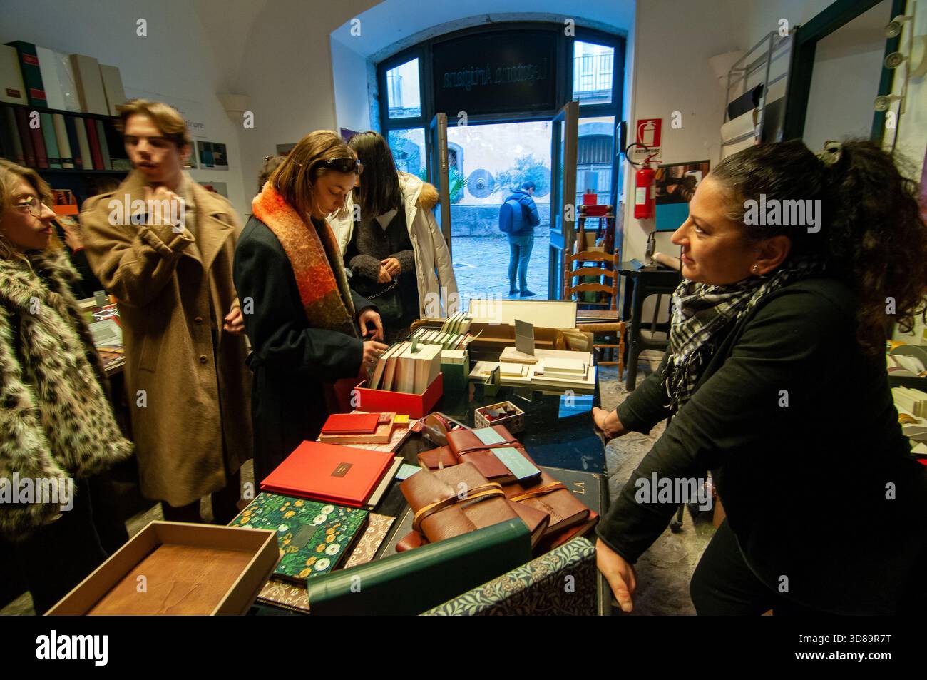Visitatori in una cartiera nel cortile di Palazzo Marigliano a Spaccanapoli, centro storico di Napoli. Foto Stock
