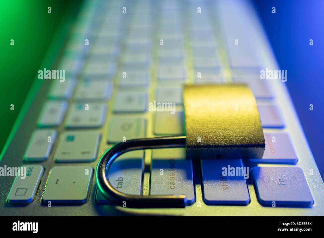 Un lucchetto sicuro poggia sulla tastiera di un computer, che rappresenta l'importanza della sicurezza informatica e della protezione dei dati personali online. L'impostazione è illum Foto Stock