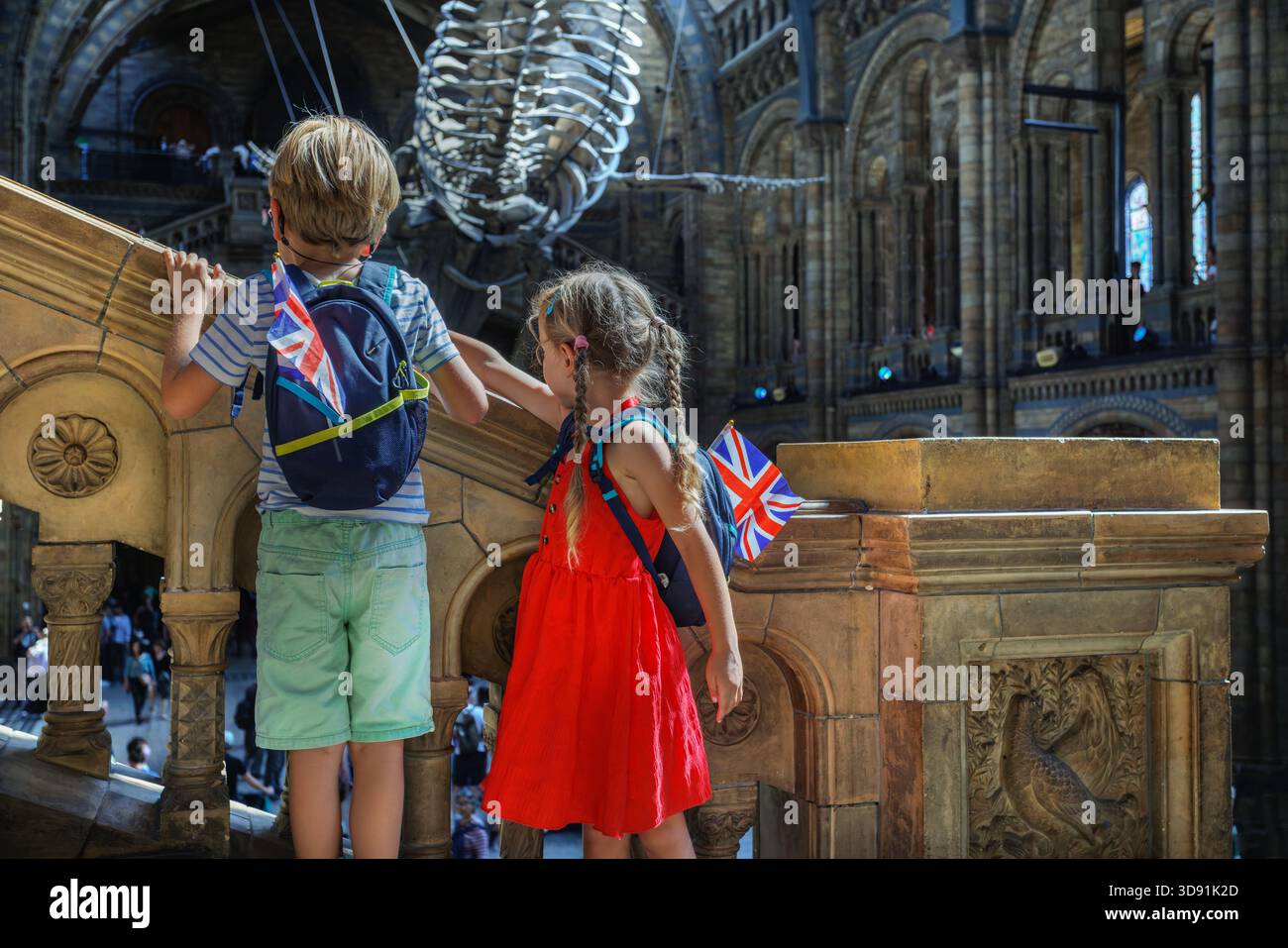 Due bambini, all'interno della sala del museo con uno scheletro di balena Foto Stock