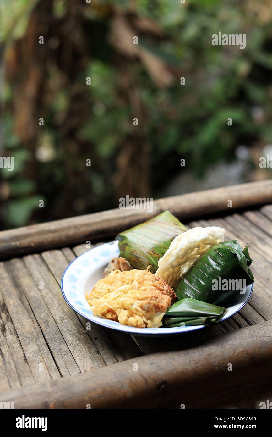 Nasi Timbel, tradizionale riso sundanese avvolto con foglia di banana Foto Stock