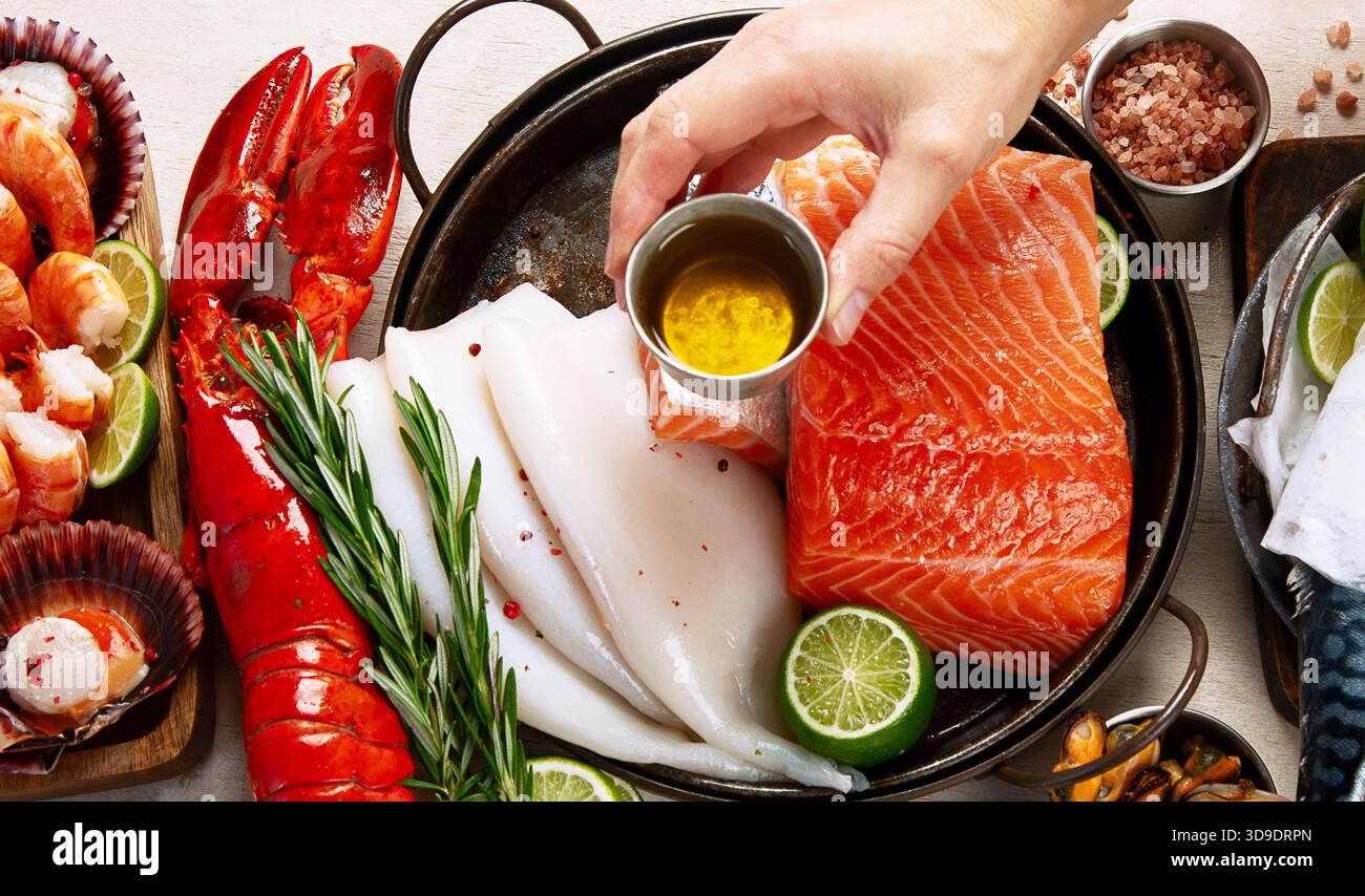 Varietà di pesce fresco ed erbe aromatiche. Pesce fresco e specialità di pesce. Vista dall'alto. Foto Stock