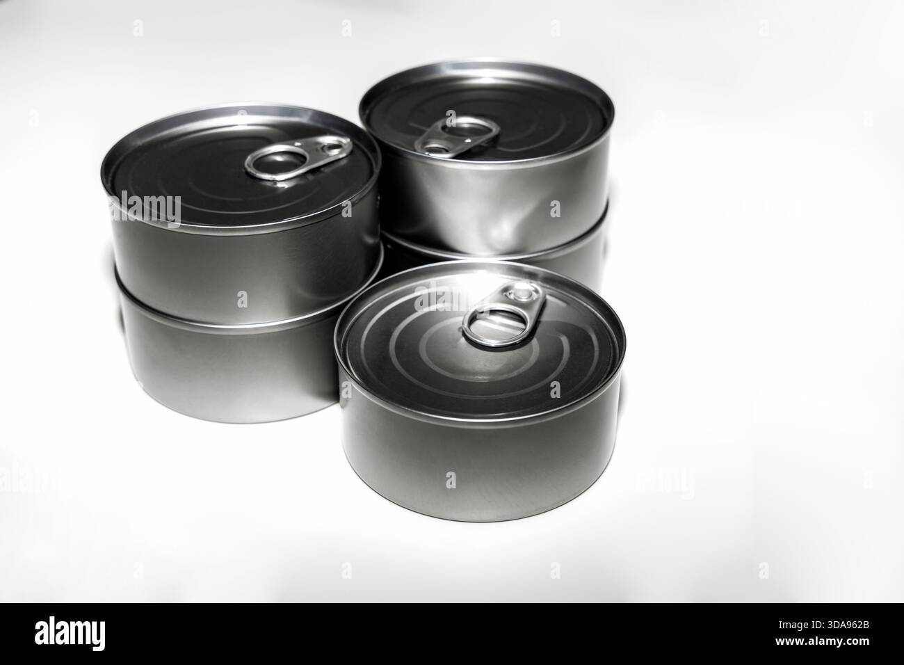 Forniture alimentari per tonno in scatola in contenitori di alluminio su sfondo bianco Foto Stock