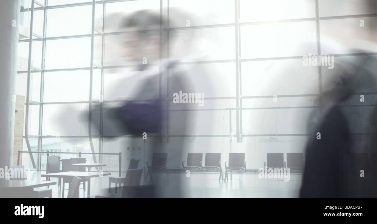 I professionisti che viaggiano per affari camminano velocemente nella moderna lobby degli uffici con grandi finestre Foto Stock