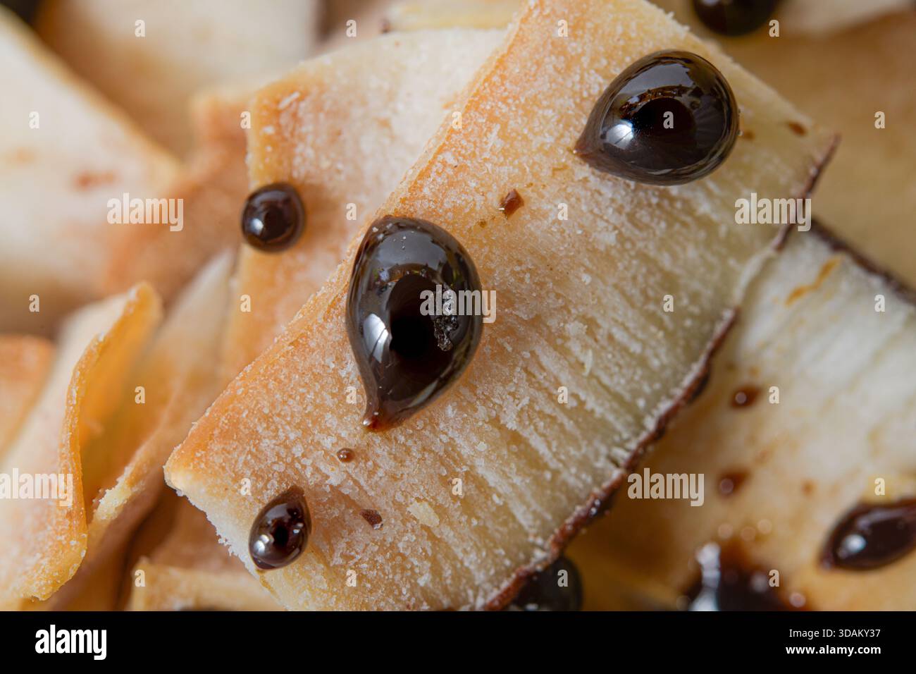 Macinatura di pezzi di cocco tostati con gocce di cioccolato lucido. Foto Stock
