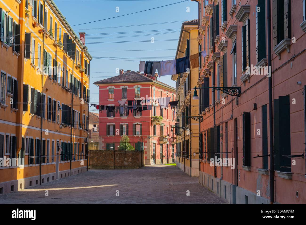 Viuzze colorate, stradina residenziale a Venezia, Italia, facciate colorate, finestre con persiane, lavanderia sospesa. Foto Stock