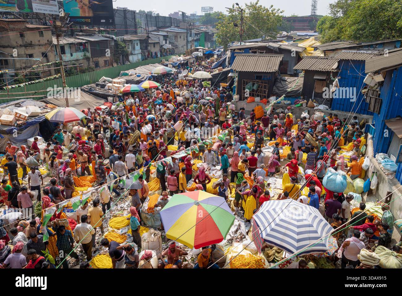 Folle di persone che comprano e vendono fiori al mercato dei fiori di Kolkata Foto Stock