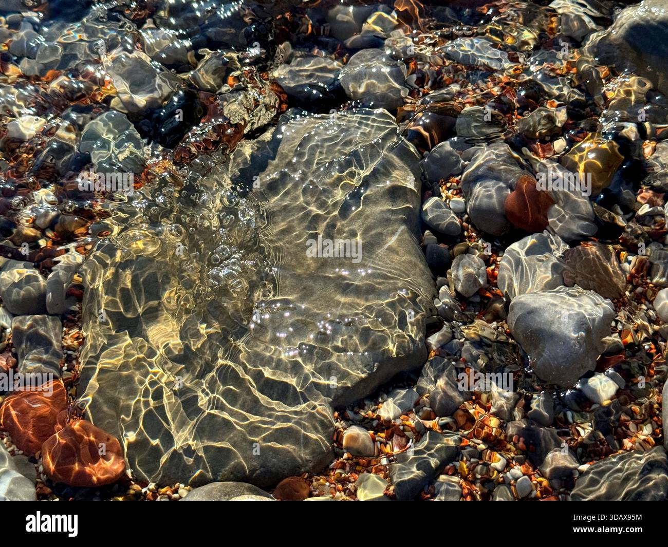 Pietre e ciottoli nell'acqua trasparente dell'oceano Foto Stock