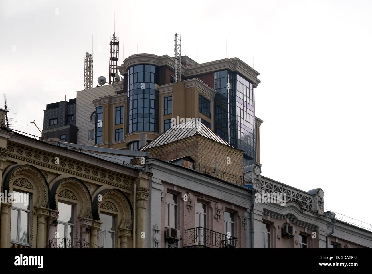 Alti ed eleganti edifici si innalzano sopra strutture storiche in un vivace ambiente urbano. Kiev, Ucraina. 12 dicembre 2025. Foto Stock