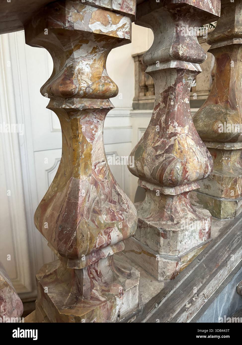 Primo piano di balaustre di marmo variegate e riccamente venate, che mostrano l'artigianalità e i colori naturali delle opere in pietra architettoniche storiche. Foto Stock