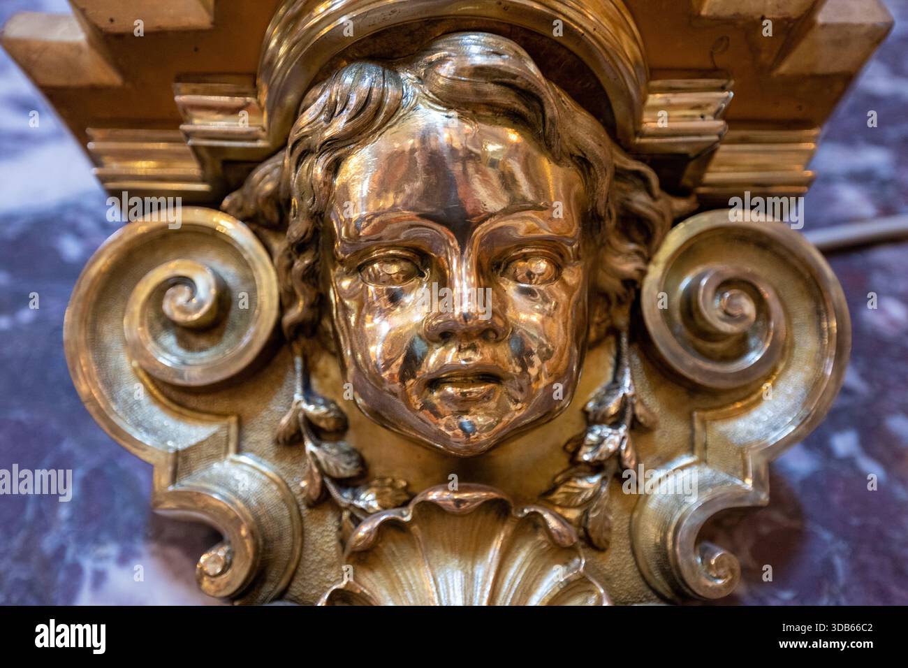 Bologna, Italia - 24 luglio 2025: Primo piano di un dettaglio di cherubino dorato barocco all'interno del Santuario di nostra Signora di San Luca sopra la pietra marmorizzata di Bologna. Foto Stock