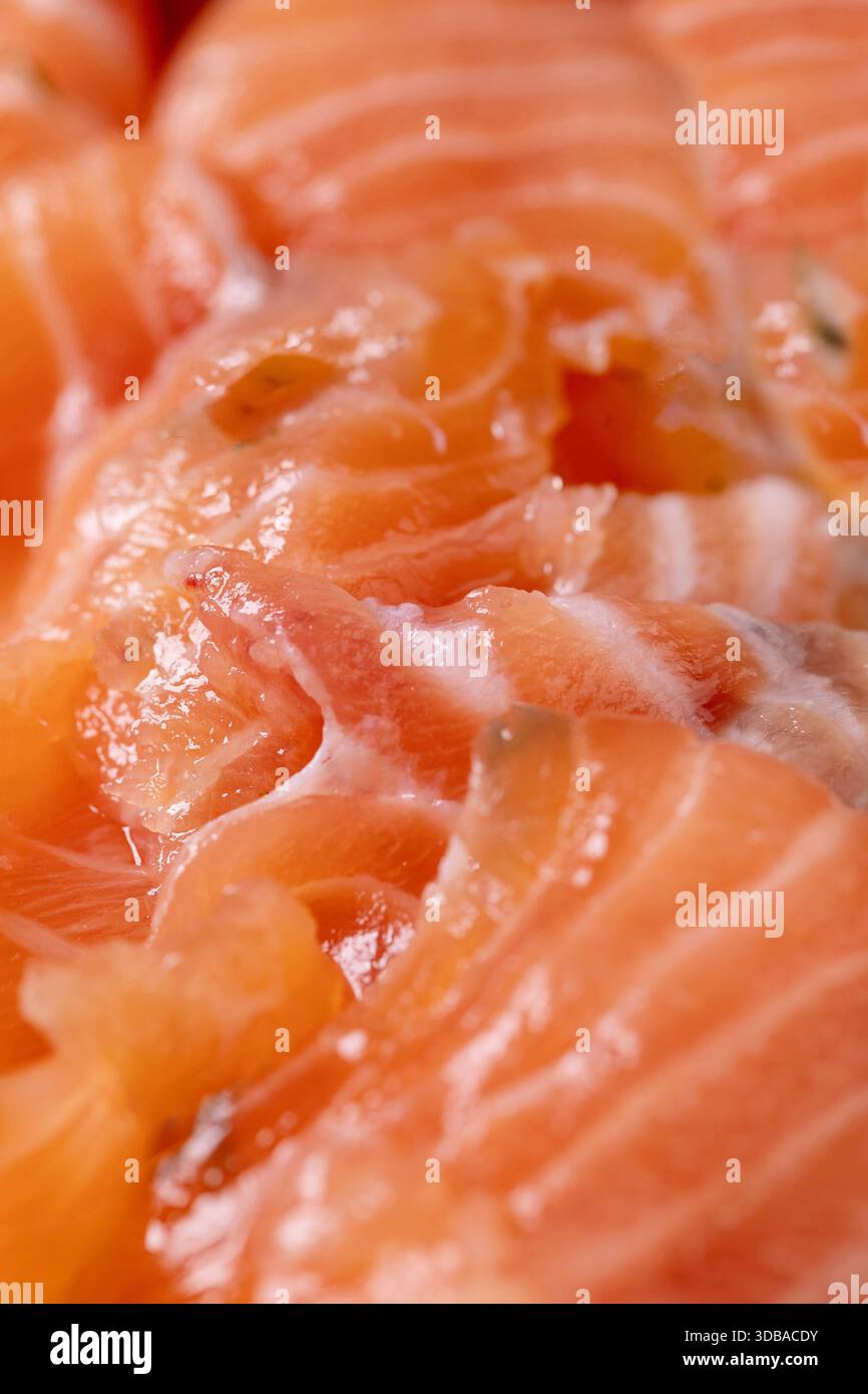 Filetto di salmone salato a fette sottili. Primo piano, sfondo con cibo di mare, macrofotografia Foto Stock