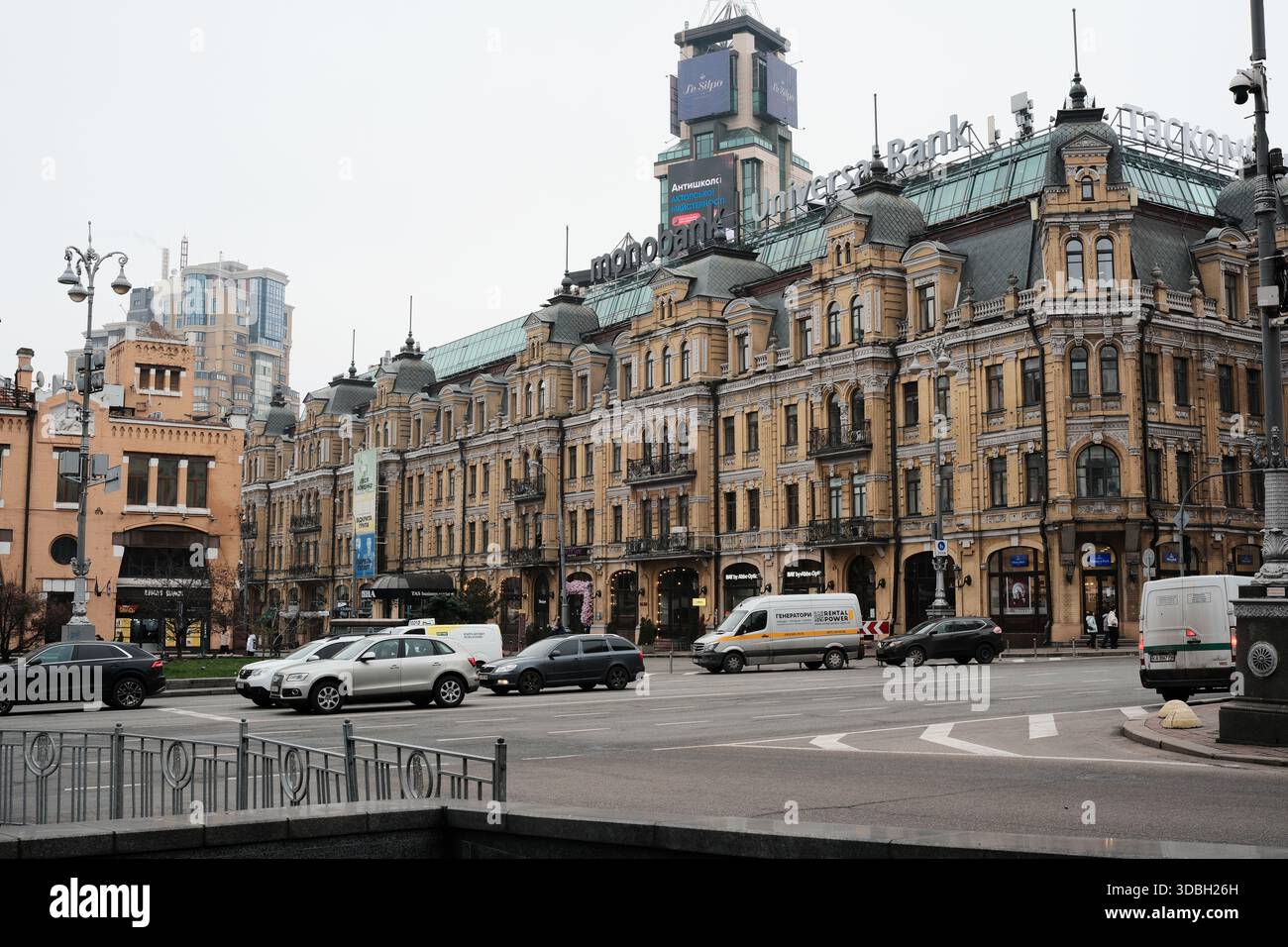 Eleganti edifici fiancheggiano il viale affollato mentre i veicoli navigano nel paesaggio urbano. Kiev, Ucraina. 16 dicembre 2025. Foto Stock