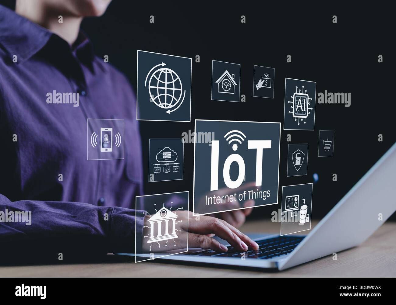Concetto di tecnologia Internet delle cose (IoT). Una persona che utilizza un notebook con icone IoT che rappresentano dispositivi intelligenti, connettività e vari tipi di Internet of Th Foto Stock