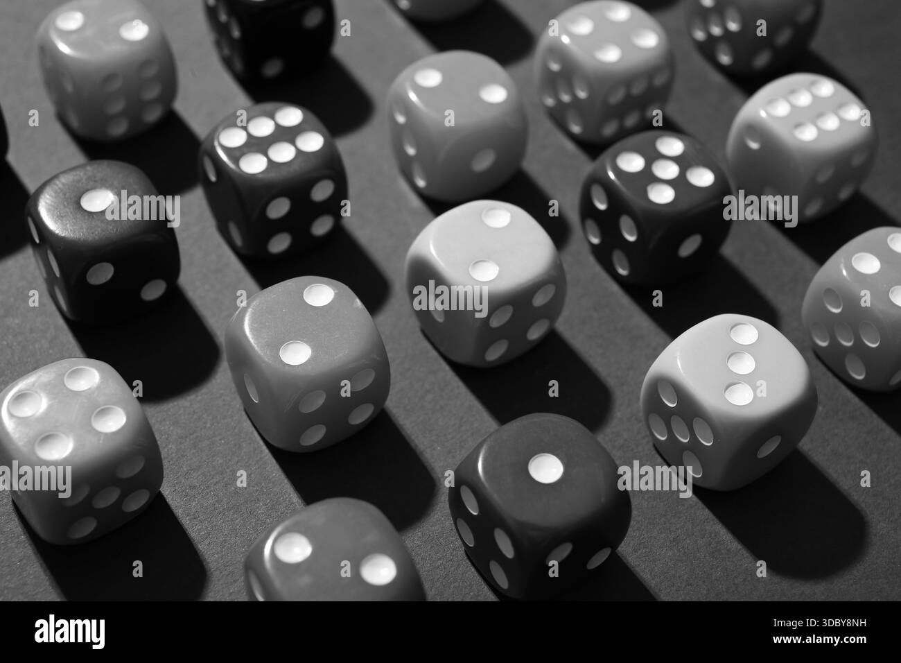 Molti dadi di gioco su sfondo grigio, primo piano Foto Stock