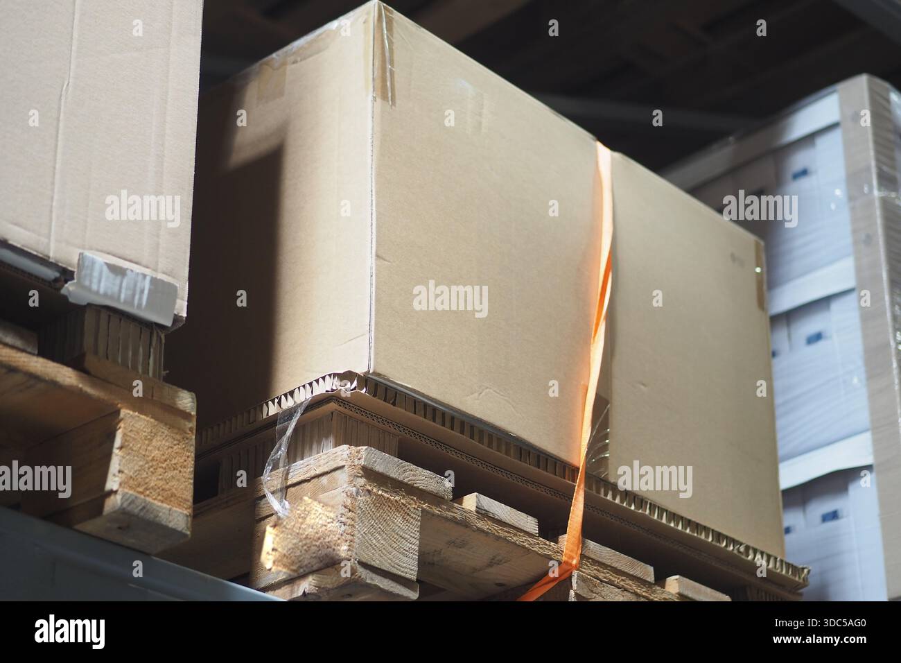 Scatole impilate su pallet di legno in un magazzino di stoccaggio Foto Stock
