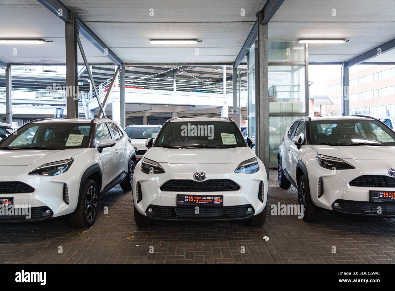 Vista frontale delle auto Toyota bianche esposte fianco a fianco presso una concessionaria di Dusseldorf Foto Stock