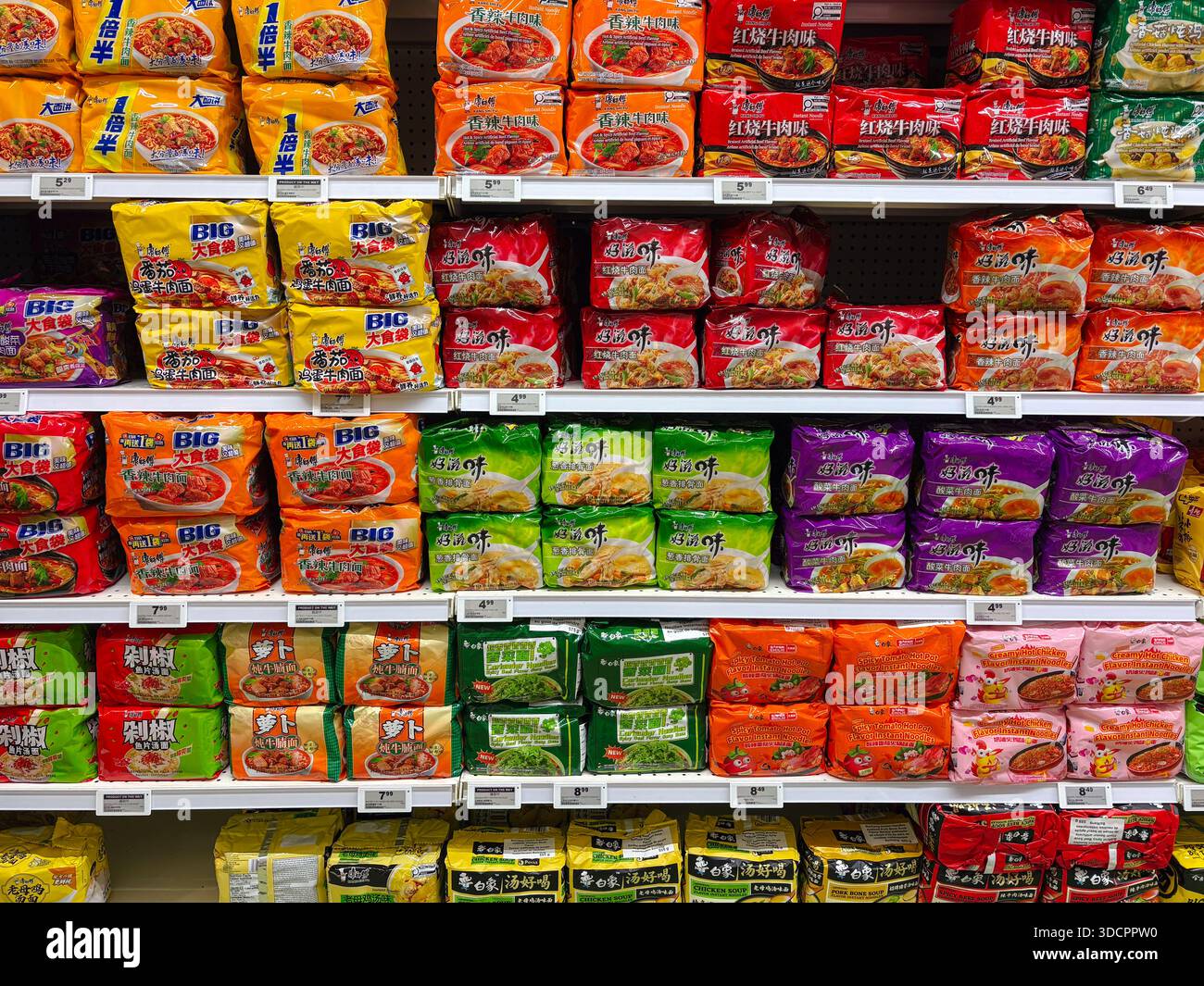 Mastro Kong e uni-President spaghetti istantanei. Ramen, zuppa veloce. Selezione di pacchetti di spaghetti aromatizzati sugli scaffali in un corridoio di supermercato asiatico. Foto Stock