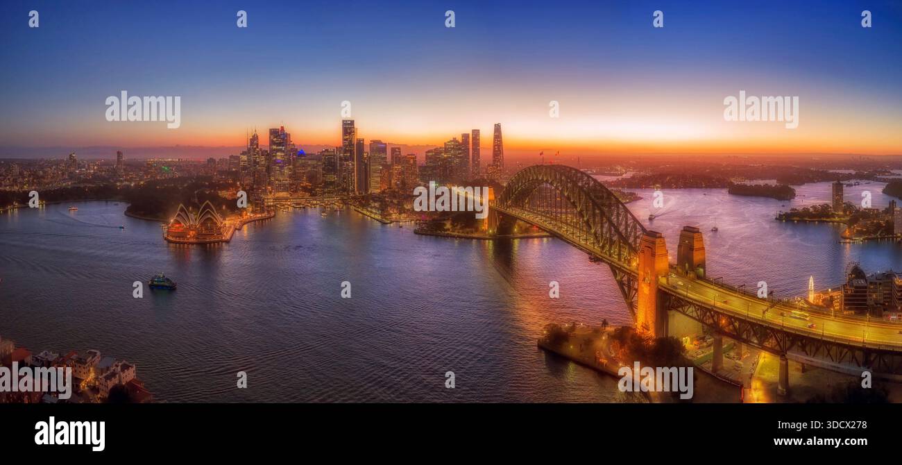 Il lungomare del CBD di Sydney attraversa il porto dal ponte di Kirribilli con vista aerea della città all'ora del tramonto. Foto Stock
