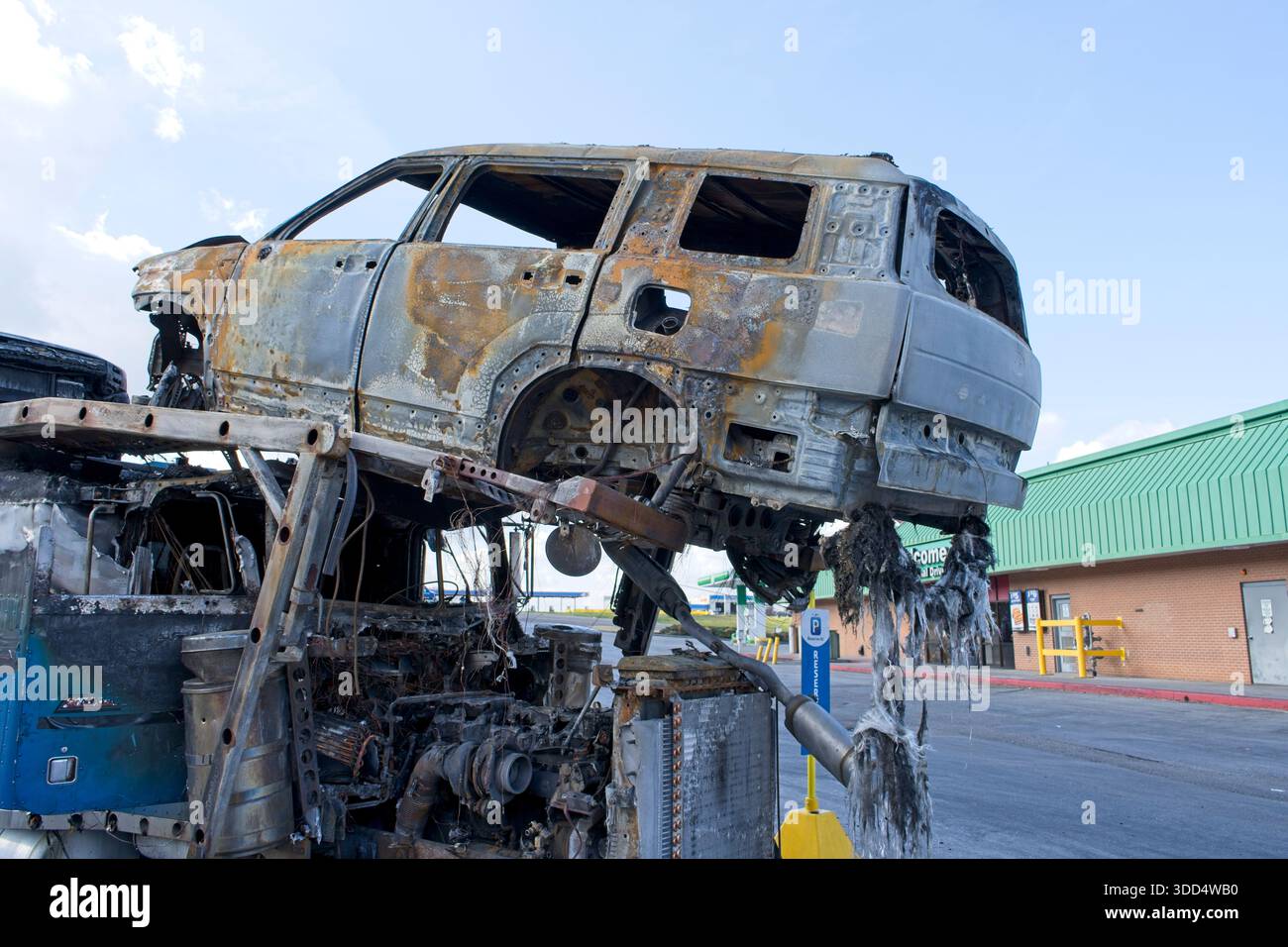 Rimorchio portante per semi-camion bruciato con gusci distrutti e arrugginiti dopo un incendio Foto Stock