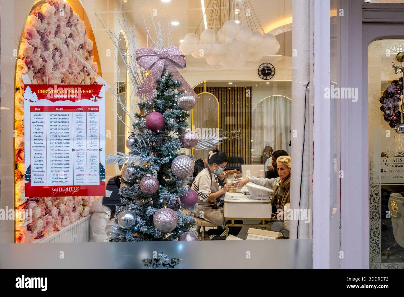 A Young Woman has her Nails done at A Nail Salon at Christmas Time, Canterbury, Kent, UK. Foto Stock