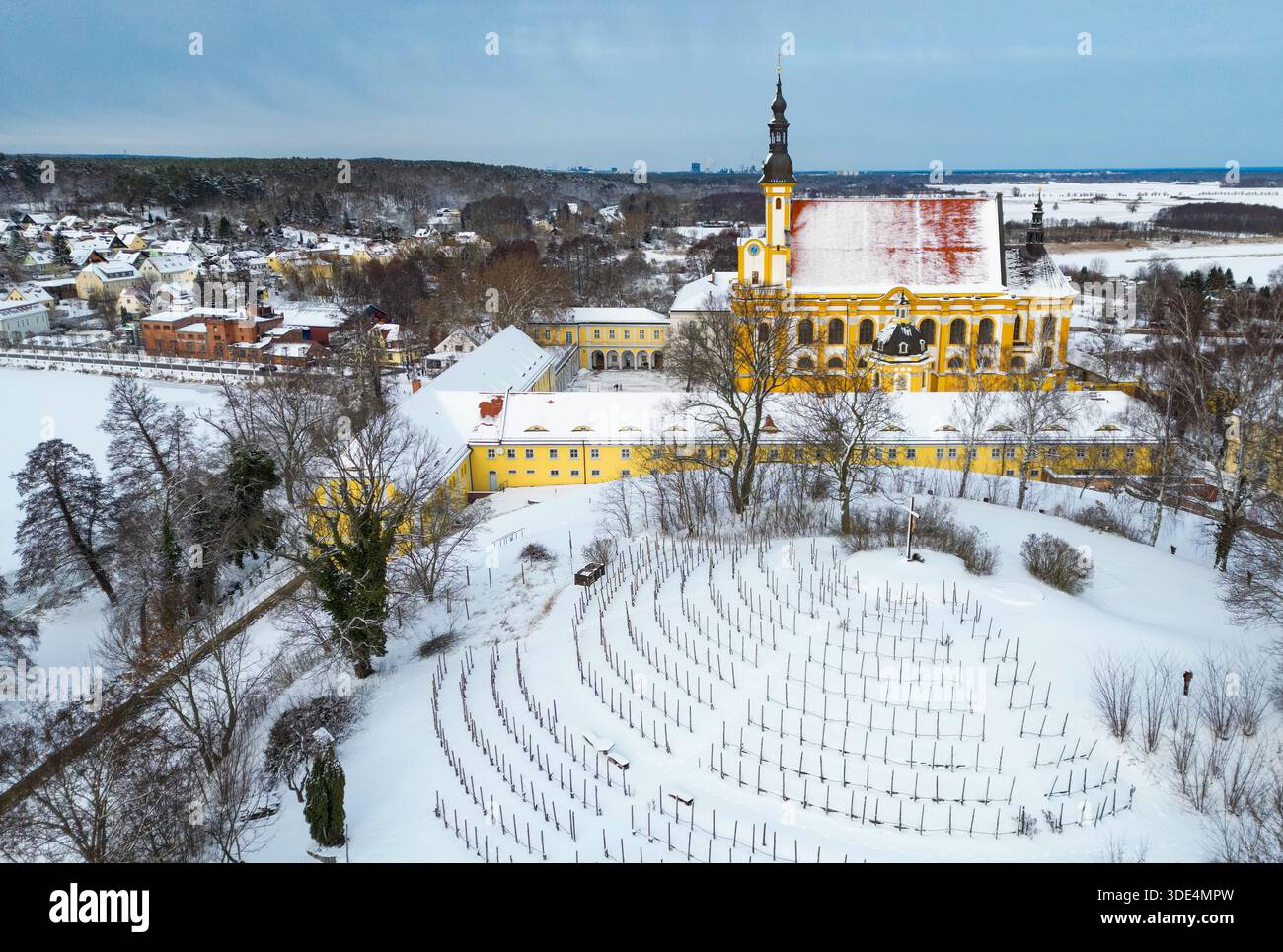 Neuzelle, Germania. 3 gennaio 2026. La chiesa cattolica e il vigneto del monastero di Neuzelle sono ricoperti di neve (vista aerea con un drone). Il monastero di Neuzelle, a circa dieci chilometri a sud di Eisenhüttenstadt, è l'unico monastero cistercense completamente conservato nel Brandeburgo, compresi i terreni, e uno dei pochi complessi monastici non distrutti in Germania e in Europa. Crediti: Patrick Pleul/dpa/Alamy Live News Foto Stock