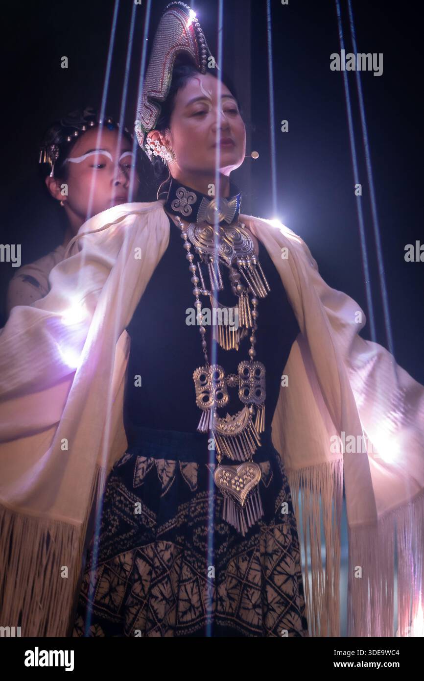 Drammatico ritratto in condizioni di scarsa illuminazione di due donne che indossano un elaborato abbigliamento tradizionale, con gioielli in argento ornati e copricapi cerimoniali. Mistico. Foto Stock