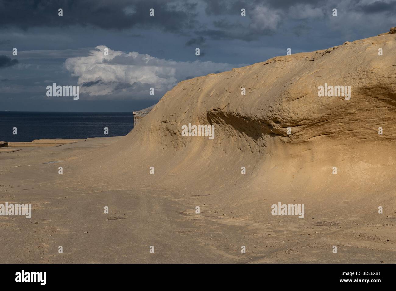 Le formazioni rocciose di arenaria modellate dal vento e dal mare creano curve lisce e texture a strati lungo la costa mediterranea, evidenziando l'erosione e la natura Foto Stock