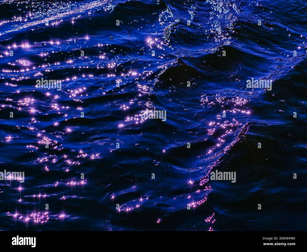Luce del mattino scintillante sul mare blu ondulato - elegante trama astratta dell'acqua con riflessi luminosi del sole Foto Stock