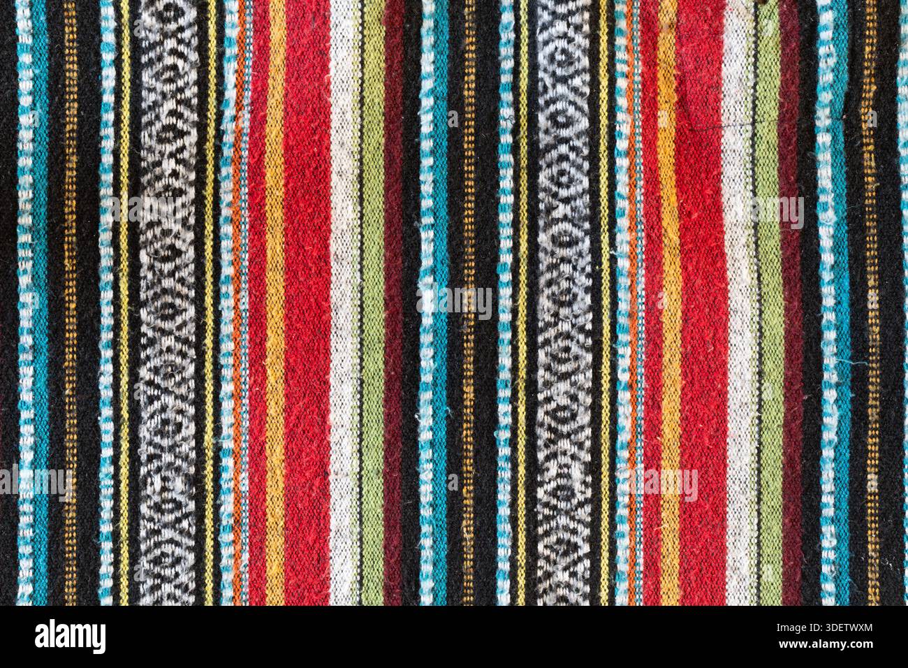 Coperta in lana nepalese o in stile messicano tribale. Linee colorate di rosso, blu, giallo e nero. Trama linee verticali tessuta da carta spazzolata Foto Stock