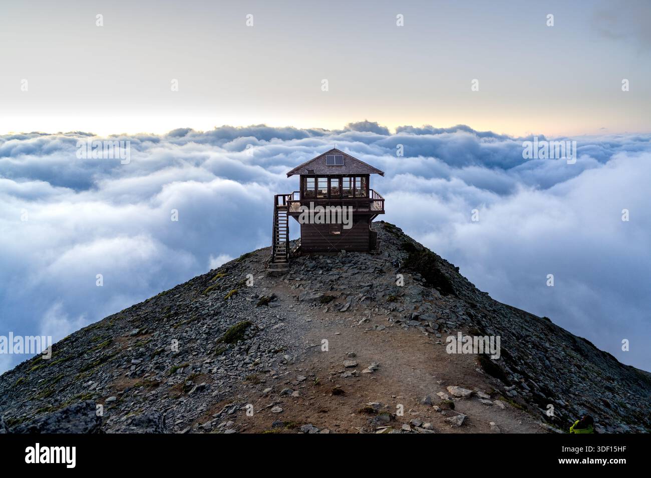 Torre di osservazione del fuoco sopra i couds al tramonto al Mount Rainer National Park, Washington State, USA Foto Stock