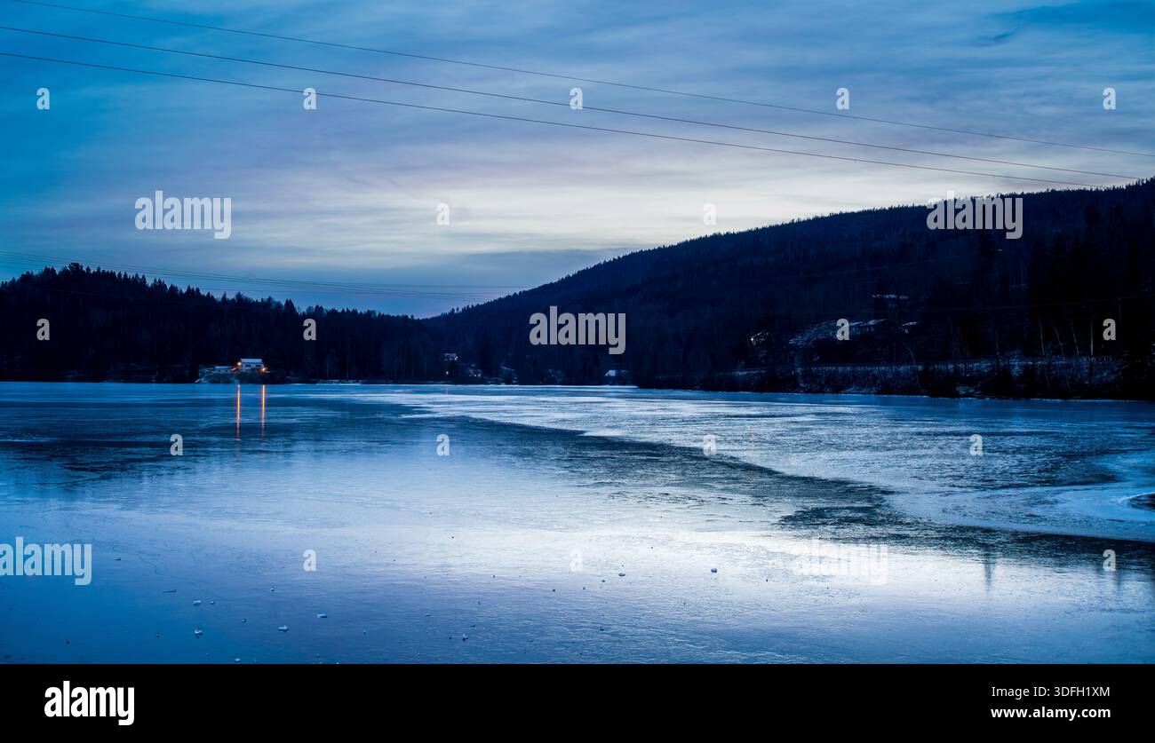 Lago ghiacciato con aspetto Moody e Cold durante un inverno nordico Foto Stock