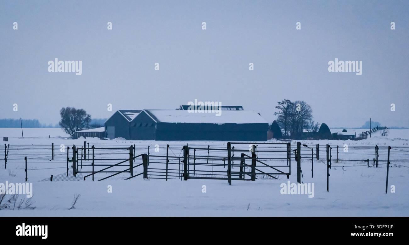 Fattoria in un paesaggio invernale innevato Foto Stock