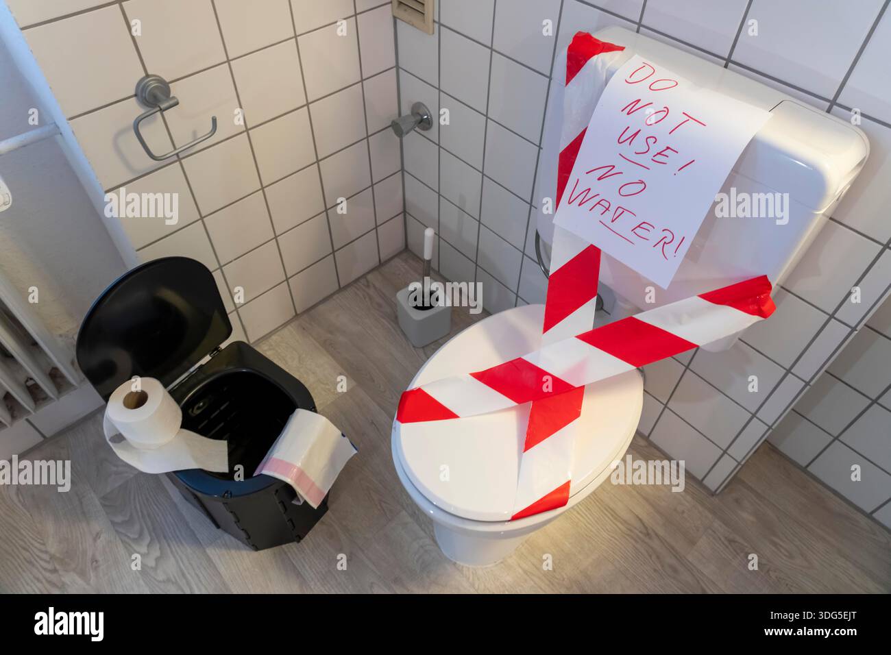 Immagine simbolica di un blackout, un'interruzione di corrente diffusa e prolungata, in un ambiente privato, senza elettricità, anche l'approvvigionamento idrico fallisce, il bagno Foto Stock