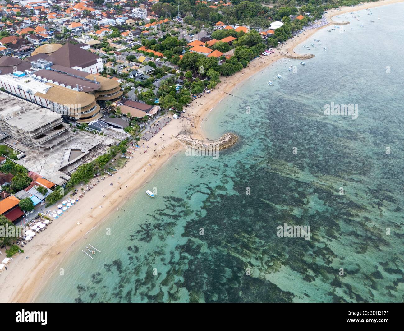 Vista aerea della spiaggia tropicale di Sanur, Bali, la costa indonesiana con acque turchesi, resort e città di mare. Foto Stock