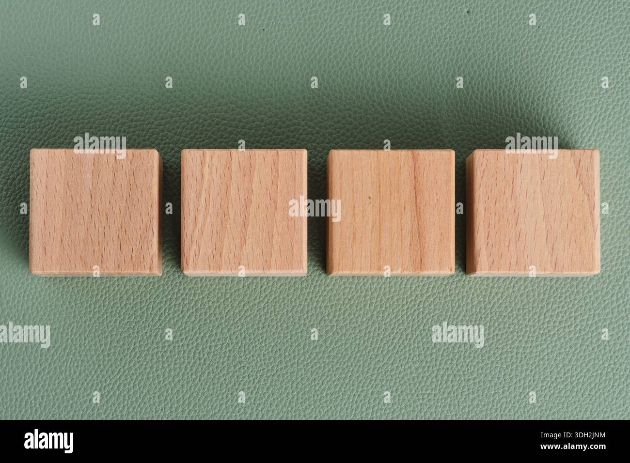 Cubetti di legno su sfondo verde in pelle. Posiziona come titolo Foto Stock