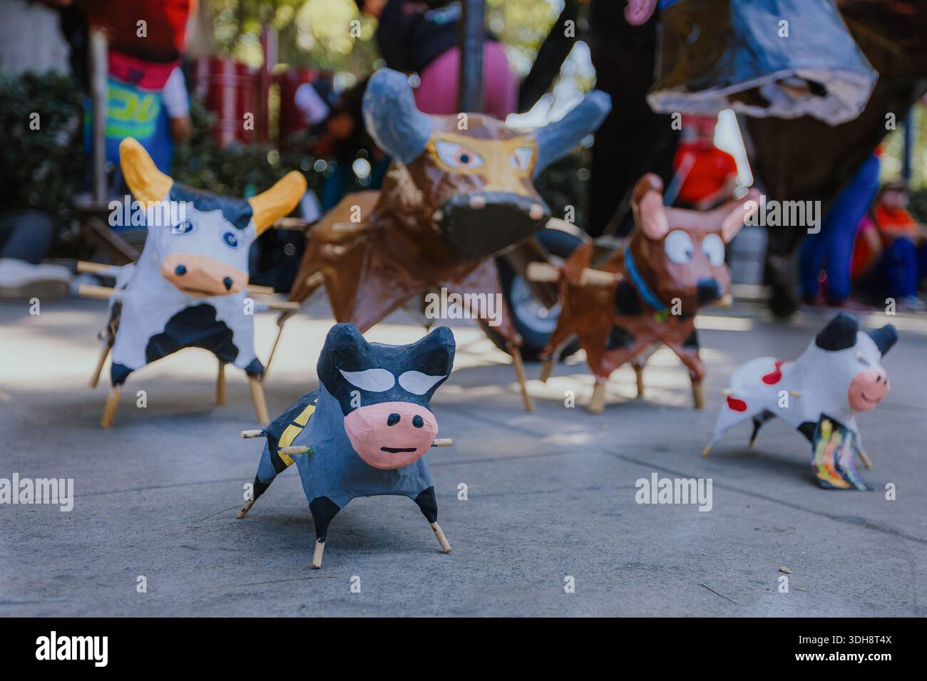 Miniature di cartone fatte a mano 'toritos' per feste folcloristiche messicane, esposte all'aperto con colori vivaci e artigianato tradizionale Foto Stock