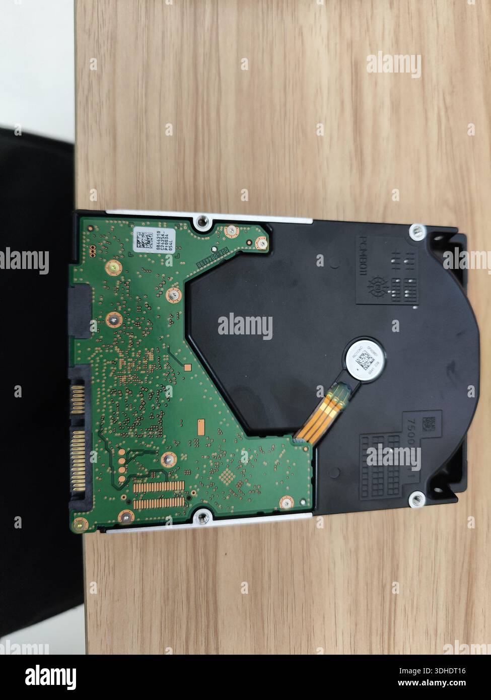 Scheda del disco rigido interno e componenti su una superficie in legno Foto Stock