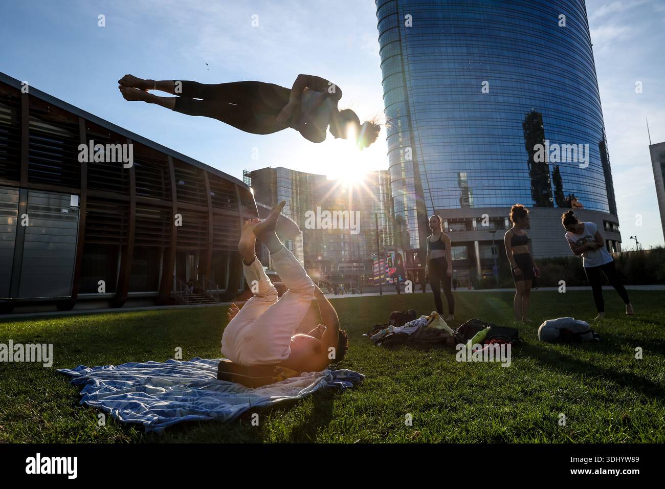 (260124) -- MILANO, 24 gennaio 2026 (Xinhua) -- le persone praticano yoga aerobatico vicino al Bosco verticale a Milano, 17 settembre 2025. I Giochi Olimpici invernali Milano-Cortina 2026 si svolgeranno dal 6 al 22 febbraio. (Xinhua/li Jing) Foto Stock