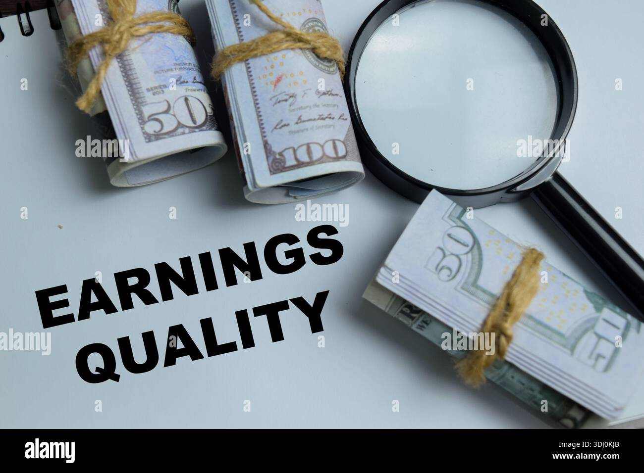 Concetto di qualità dei guadagni scrivere su libro isolato su tavolo in legno. Rappresentare la valutazione del profitto sostenibile e la rendicontazione finanziaria Foto Stock
