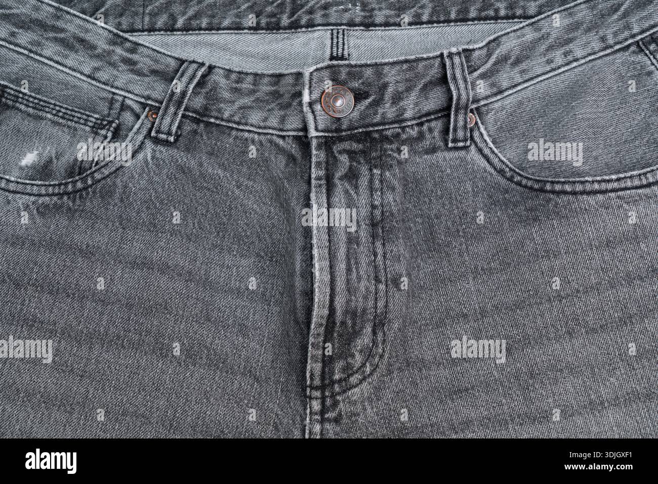 dettaglio di un paio di jeans grigi Foto Stock