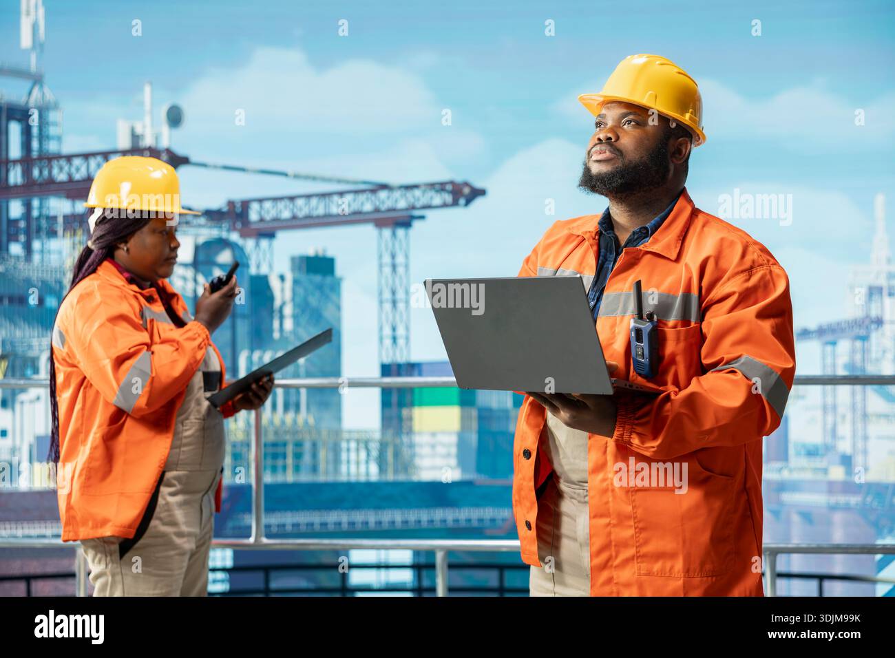 I lavoratori della piattaforma di perforazione offshore monitorano le operazioni di estrazione del gas utilizzando un computer portatile e un tablet sul ponte della piattaforma petrolifera. I colleghi del carro di perforazione lavorano insieme, analizzando le operazioni energetiche utilizzando i dispositivi Foto Stock